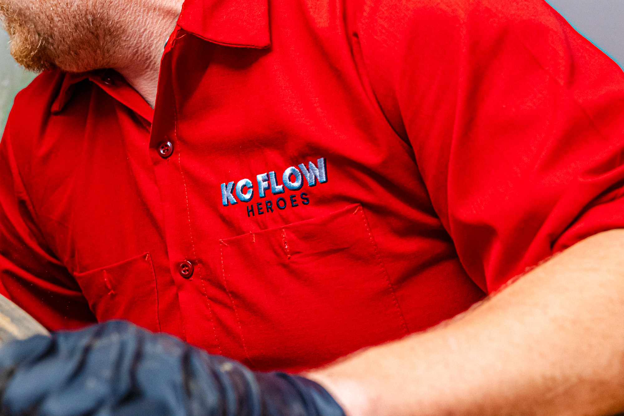 A close-up of one of our team member's uniforms as he performs drain cleaning in Olathe.