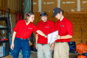 Three of our team members discuss a plan for drain cleaning in Johnson County.