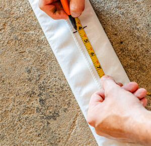 A team member measures lining for sewer repair in Leawood.