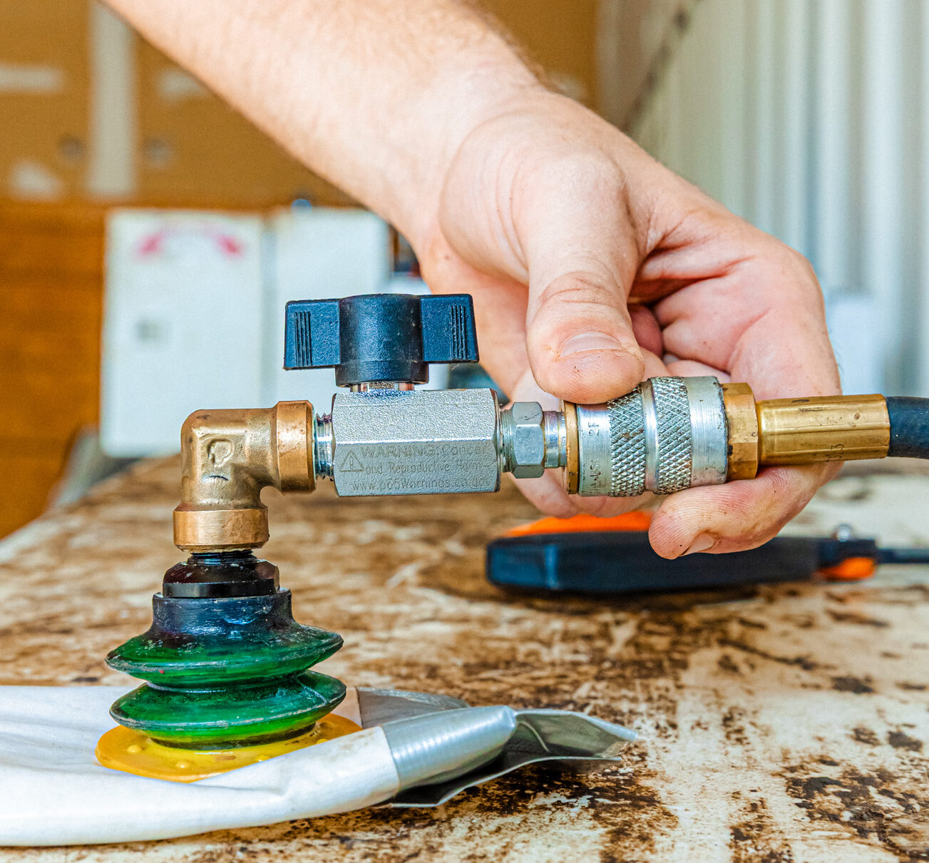 A close-up of a team member working on sewer repair in Overland Park