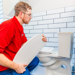 A member of our team examines a toilet before performing drain cleaning in Jackson County.