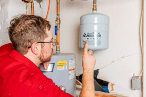 A member of our team performs water heater repair in Lee’s Summit.